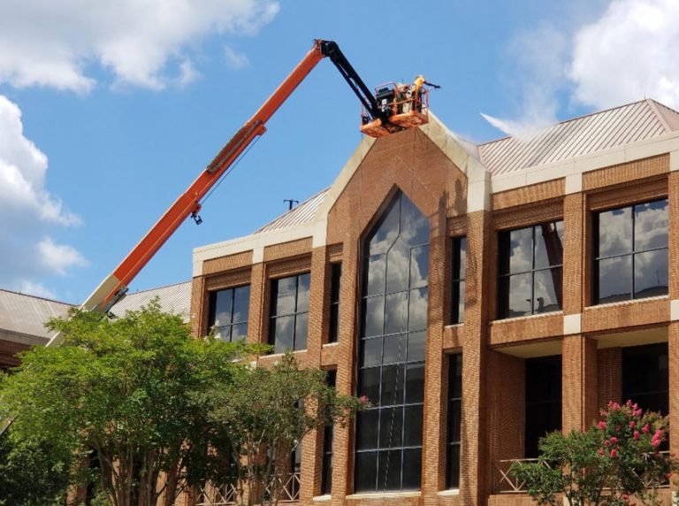 Commercial building exterior pressure washing with boom lift - Central Florida